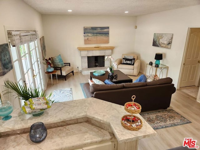 living room with wood-type flooring and a textured ceiling