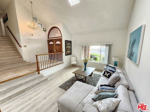 living room with a chandelier, wood-type flooring, and high vaulted ceiling