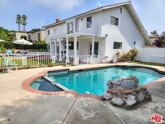 view of pool featuring a patio area and an in ground hot tub