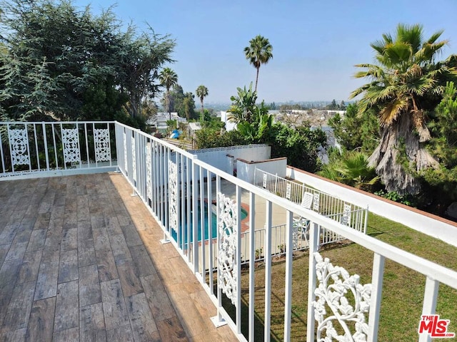 deck featuring a fenced in pool