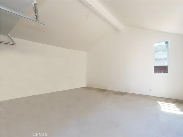 bonus room featuring concrete floors and lofted ceiling with beams