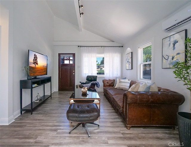 living room featuring an AC wall unit, hardwood / wood-style flooring, and lofted ceiling with beams