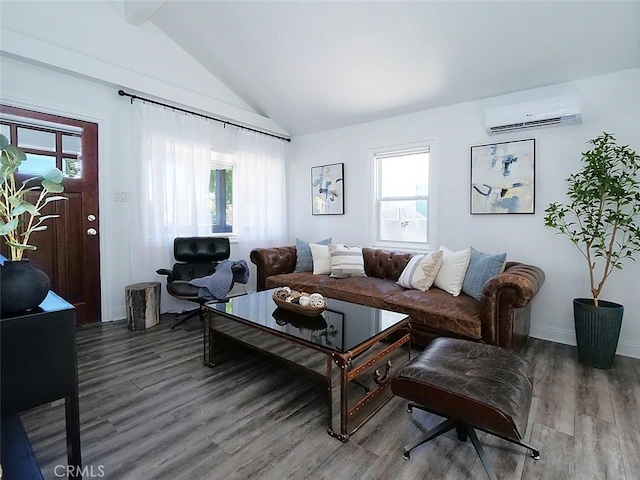 living room featuring plenty of natural light, hardwood / wood-style floors, lofted ceiling, and a wall unit AC