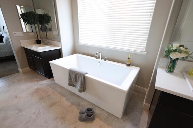 bathroom with a washtub and vanity