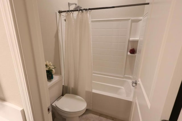 bathroom with shower / bathtub combination with curtain and toilet