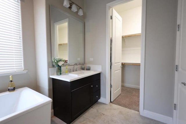 bathroom featuring vanity and a bath