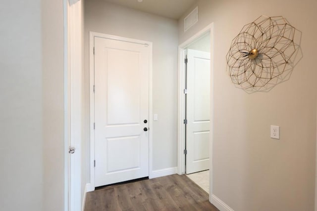 hall with wood-type flooring