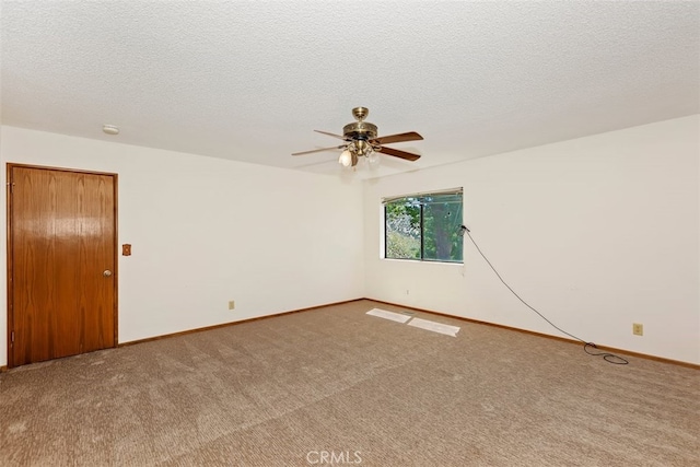 carpeted spare room with ceiling fan and a textured ceiling