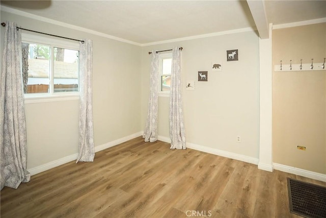 interior space with baseboards, plenty of natural light, visible vents, and wood finished floors