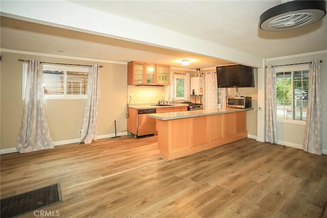 kitchen featuring visible vents, light wood-style flooring, appliances with stainless steel finishes, glass insert cabinets, and a peninsula