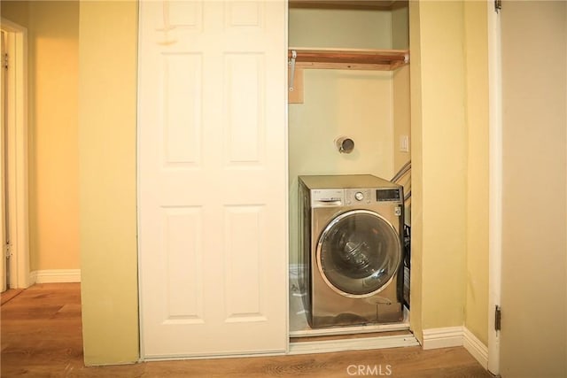 laundry room featuring washer / clothes dryer and hardwood / wood-style flooring