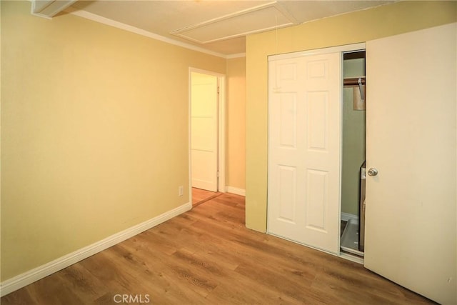 unfurnished bedroom featuring wood-type flooring and a closet