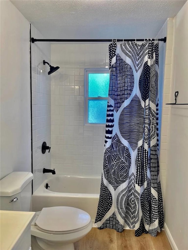 bathroom with toilet, wood finished floors, shower / bathtub combination with curtain, a textured ceiling, and vanity