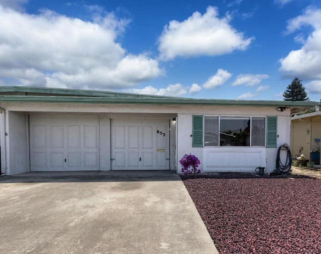 ranch-style home featuring a garage