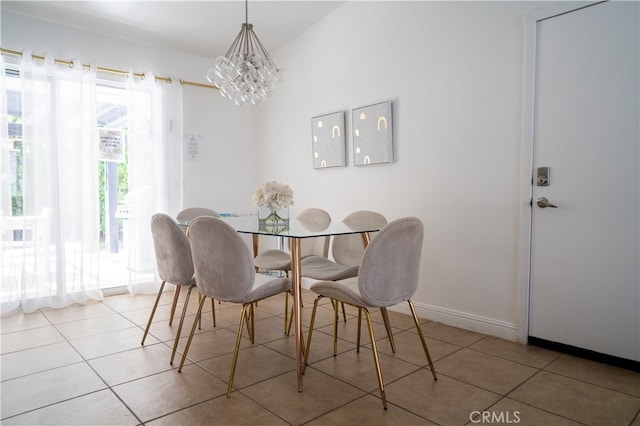 tiled dining room featuring lofted ceiling and a notable chandelier