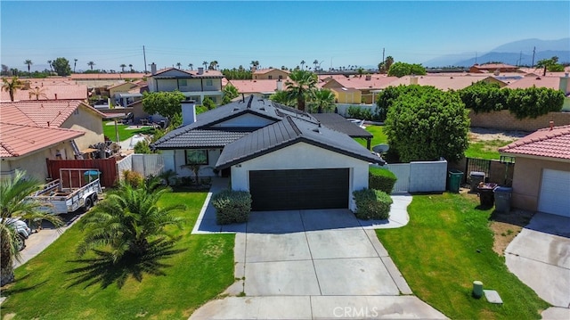 view of front of property with a front yard and a garage