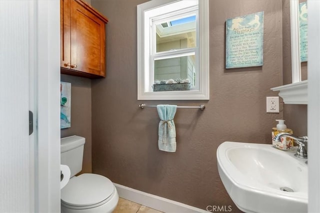 bathroom featuring tile patterned floors, toilet, and sink