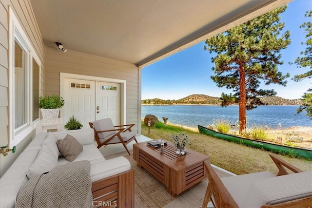 view of patio featuring outdoor lounge area and a water view