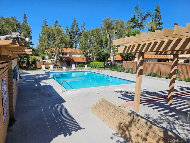 pool featuring a patio area, fence, and a pergola