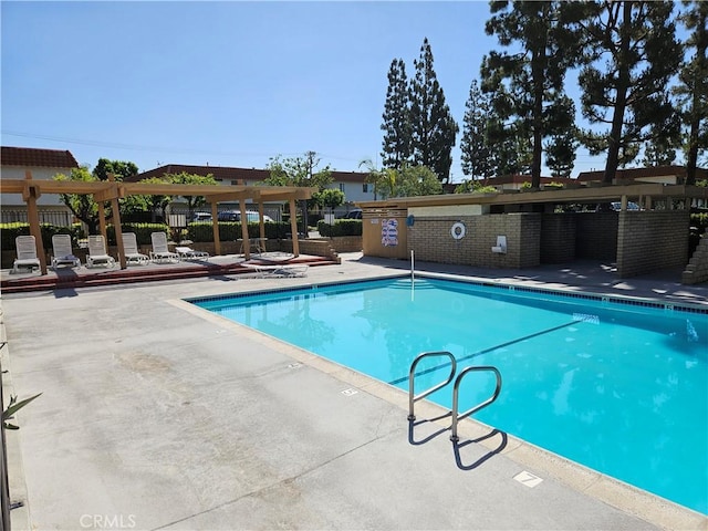 community pool featuring a patio area and fence