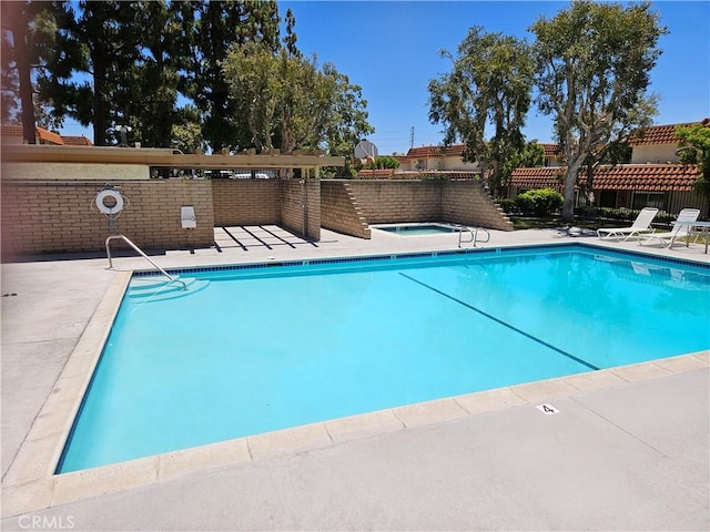 pool featuring a patio area and fence