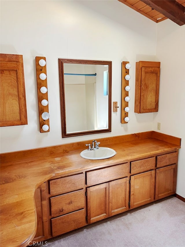 bathroom featuring wood ceiling, vanity, and beamed ceiling