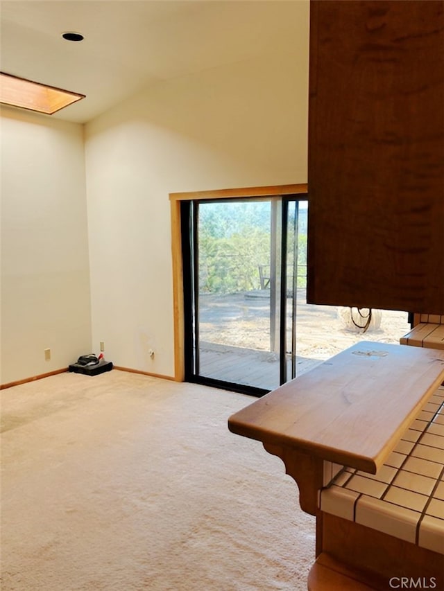 carpeted spare room with lofted ceiling