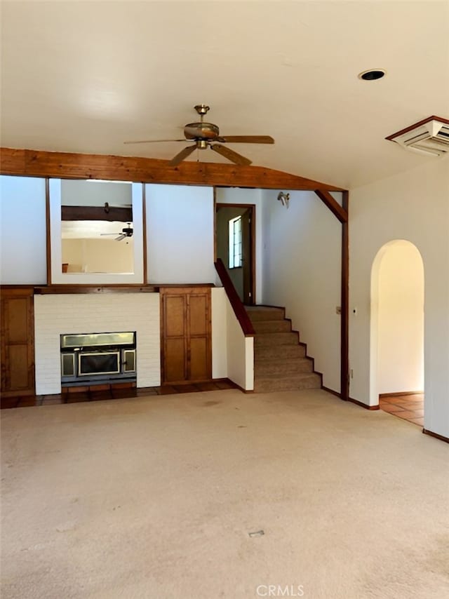 unfurnished living room featuring lofted ceiling and light colored carpet