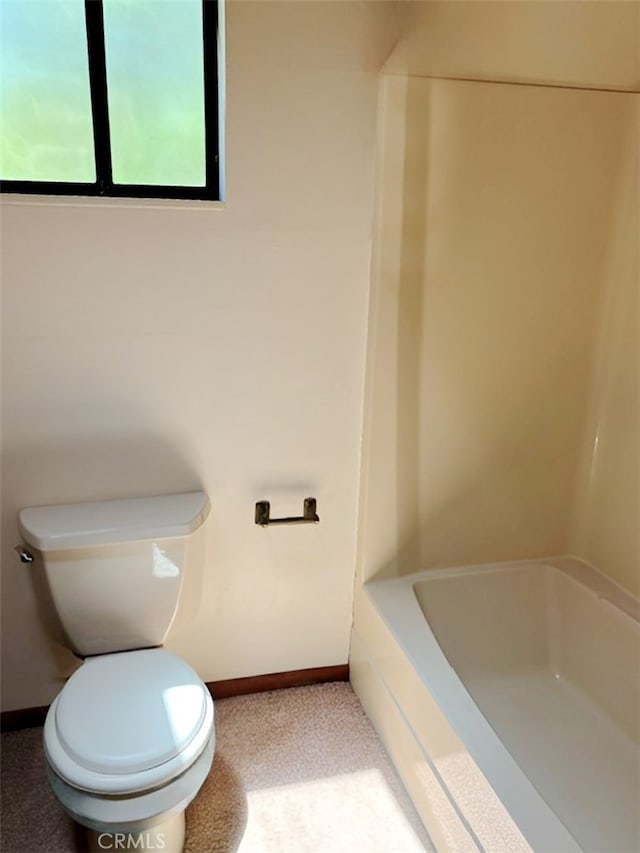 bathroom featuring a bathtub and toilet