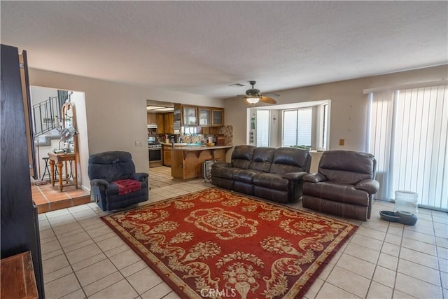 living room featuring ceiling fan and light tile patterned floors