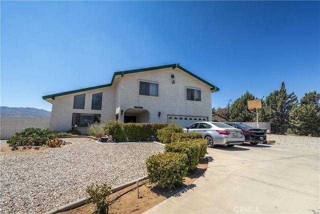 view of front of house featuring a garage and a mountain view