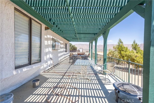 view of patio / terrace featuring a pergola and a fire pit