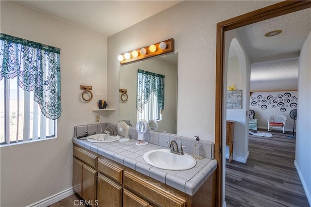 bathroom featuring vanity, a textured ceiling, and hardwood / wood-style flooring