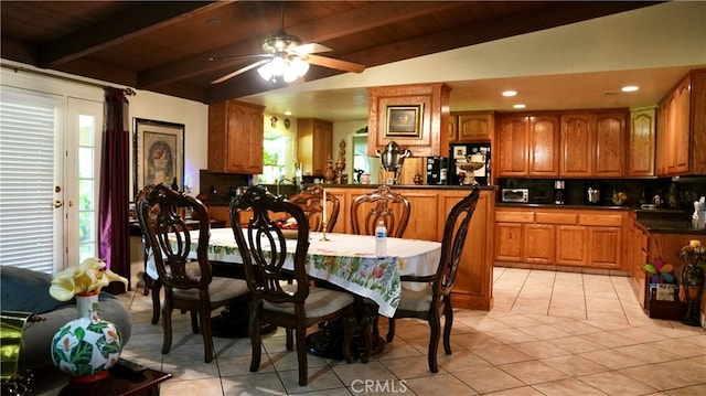 dining space with light tile patterned floors, vaulted ceiling with beams, ceiling fan, and wooden ceiling