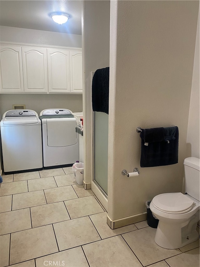 washroom with washer and dryer and light tile patterned flooring