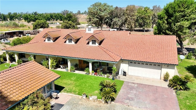 mediterranean / spanish home with a front yard and a garage