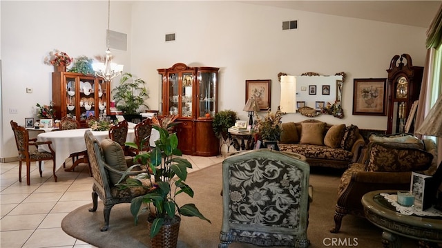 tiled living room featuring high vaulted ceiling and an inviting chandelier