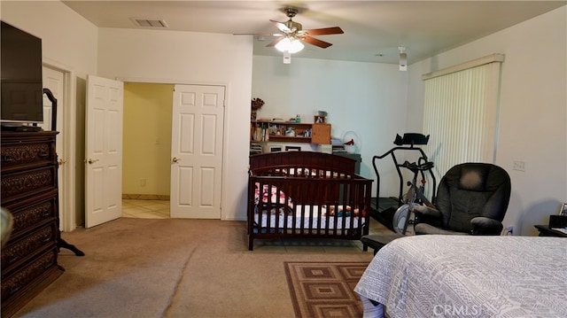 bedroom with ceiling fan and light carpet