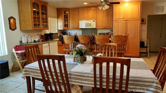 tiled dining area featuring ceiling fan