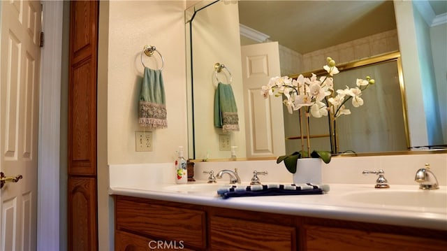 bathroom with crown molding, vanity, and an enclosed shower