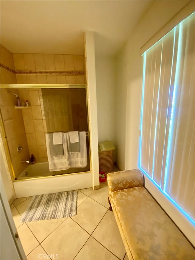 bathroom with tile patterned flooring and tiled shower / bath