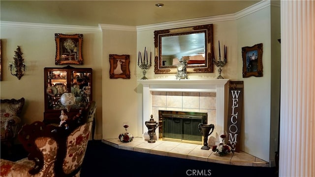 interior space featuring a tiled fireplace and crown molding