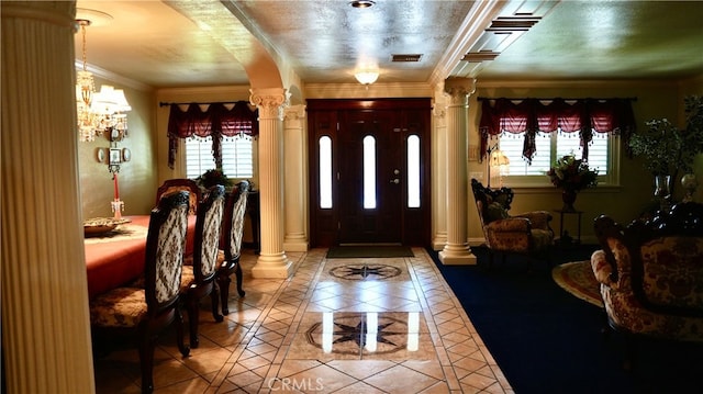 tiled foyer with ornate columns and crown molding