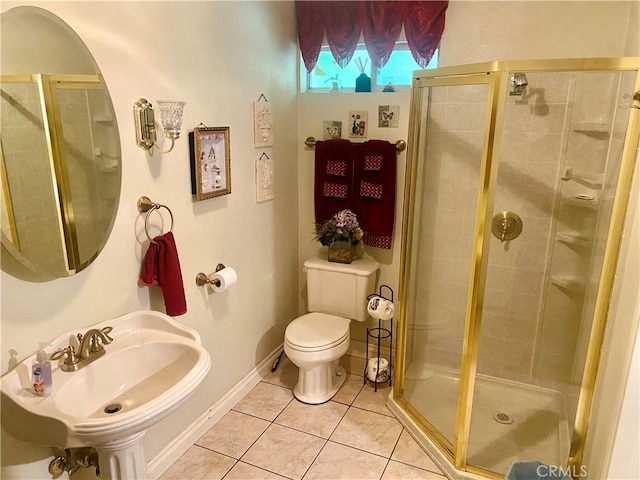 bathroom featuring sink, tile patterned flooring, a shower with shower door, and toilet