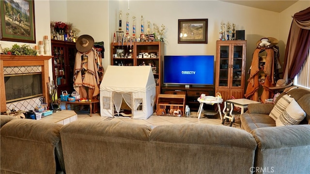 living room featuring a tiled fireplace