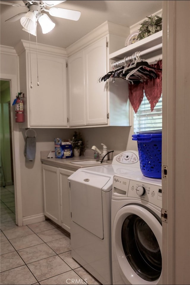 laundry area with cabinets, ornamental molding, washer and clothes dryer, sink, and light tile patterned flooring