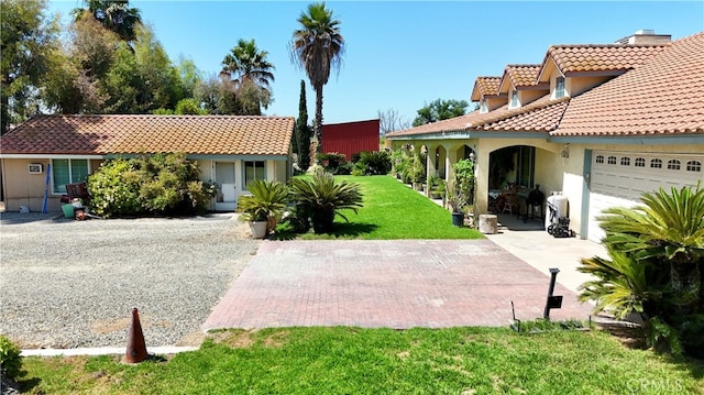 view of front of home with a front lawn and a garage