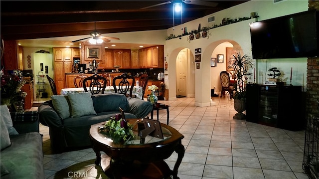 tiled living room featuring beam ceiling and ceiling fan