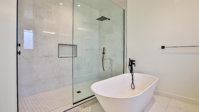 bathroom featuring shower with separate bathtub