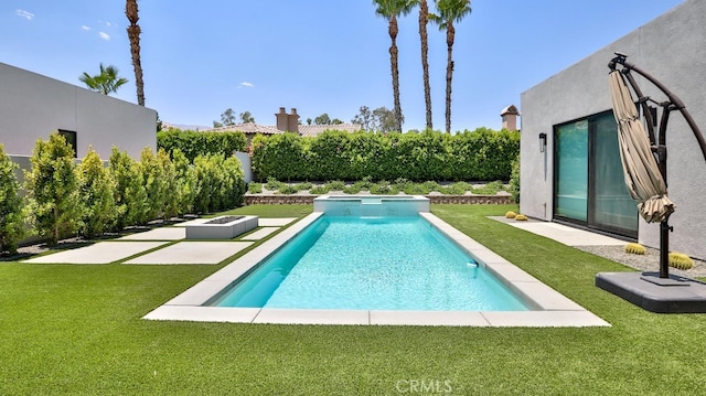 view of swimming pool with a lawn